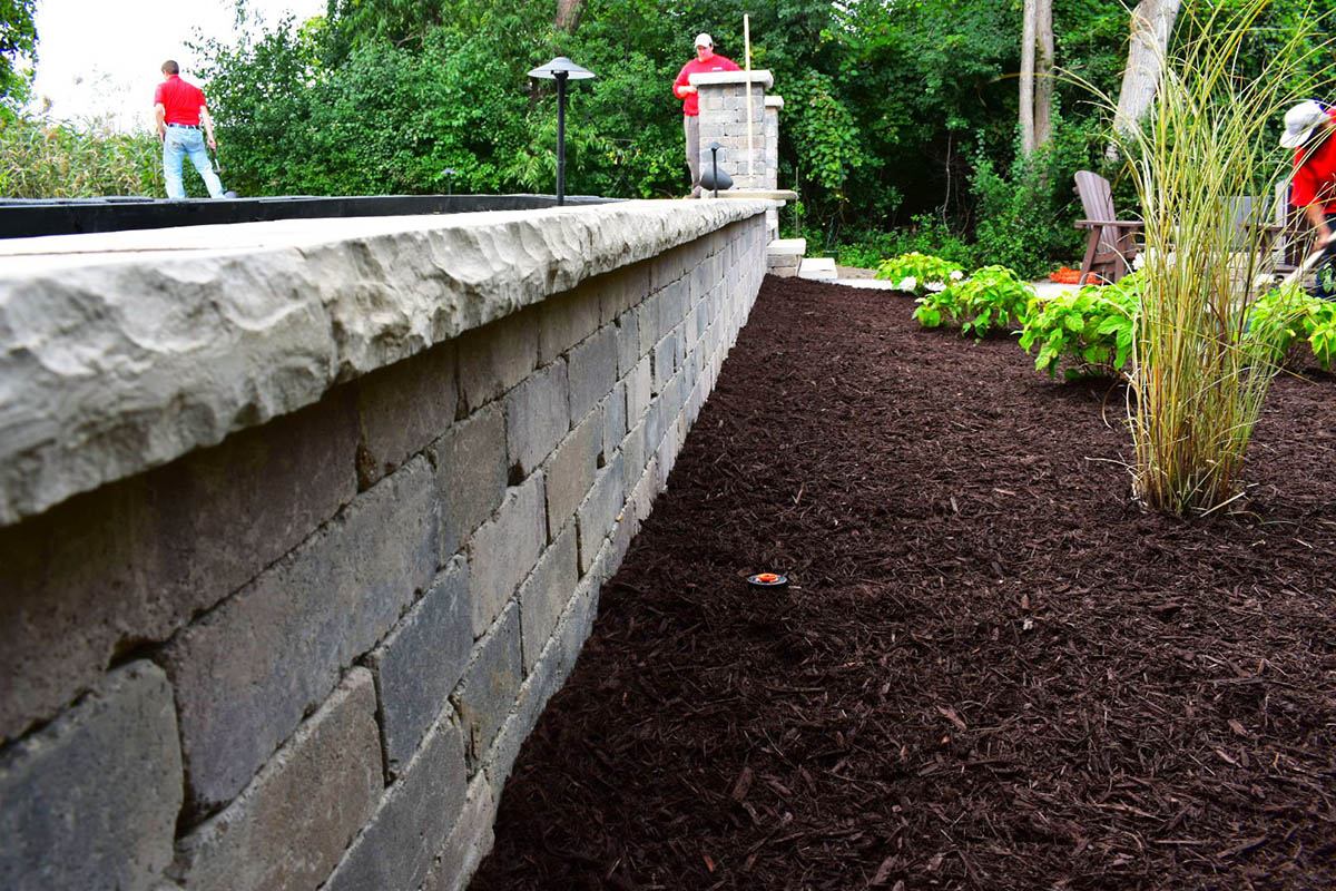 Photo of well manicured garden bed with mulch - done by Transitions Outdoor Services.