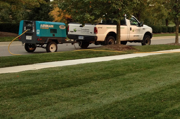 Transitions truck with aerator; yard after aeration.